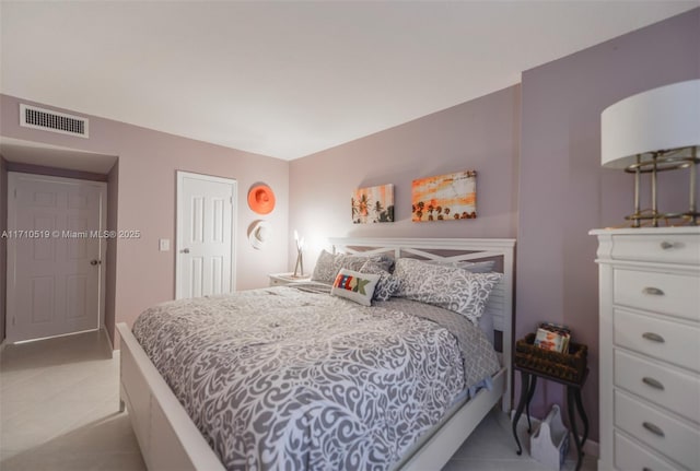 bedroom with light tile patterned floors and visible vents