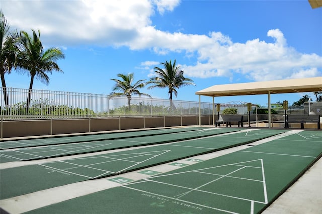 surrounding community featuring shuffleboard and fence