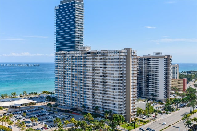 birds eye view of property featuring a water view and a city view