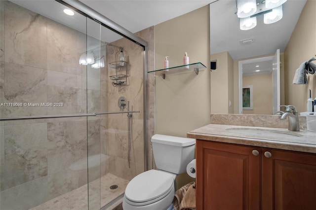 bathroom featuring vanity, toilet, and walk in shower