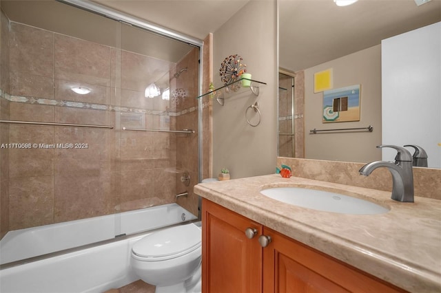 full bathroom with shower / bath combination with glass door, vanity, and toilet