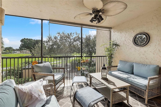 sunroom featuring ceiling fan