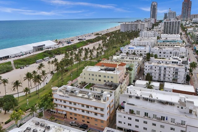 bird's eye view featuring a water view and a beach view