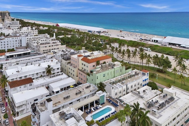 drone / aerial view featuring a beach view and a water view