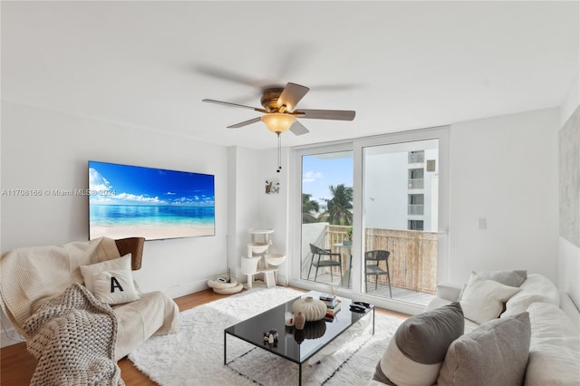 living room with wood-type flooring and ceiling fan