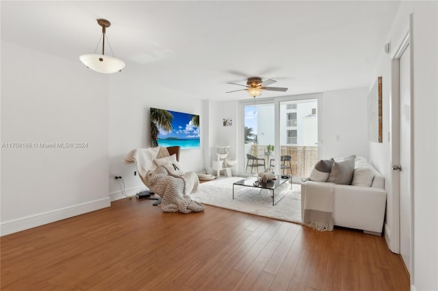 living room with hardwood / wood-style floors and ceiling fan