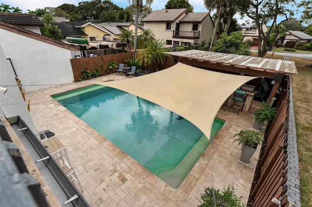 view of pool featuring a patio area and a bar