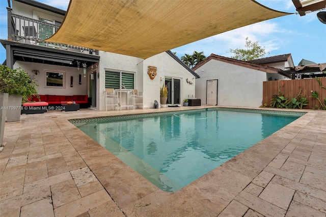 view of pool featuring central air condition unit, a patio area, and an outdoor living space