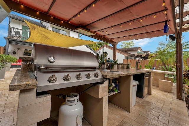 view of patio / terrace featuring area for grilling and a wet bar