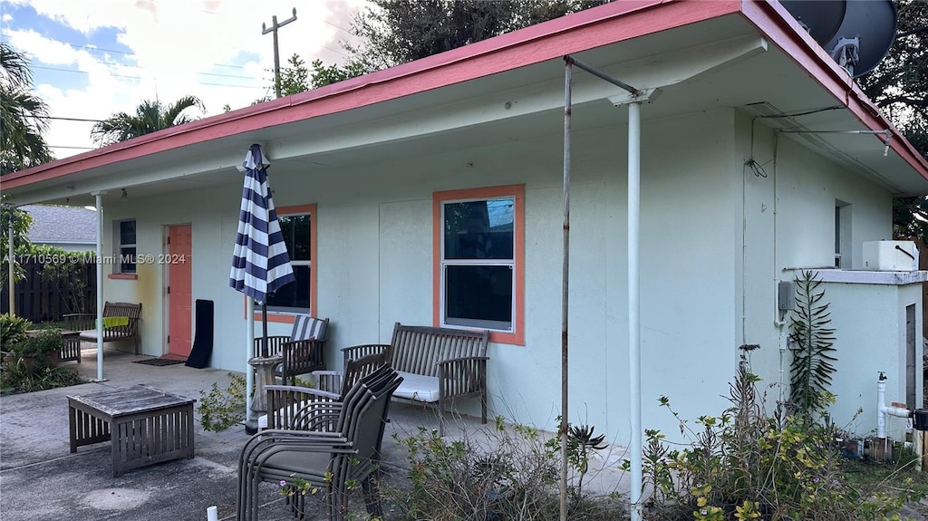 back of house featuring a porch