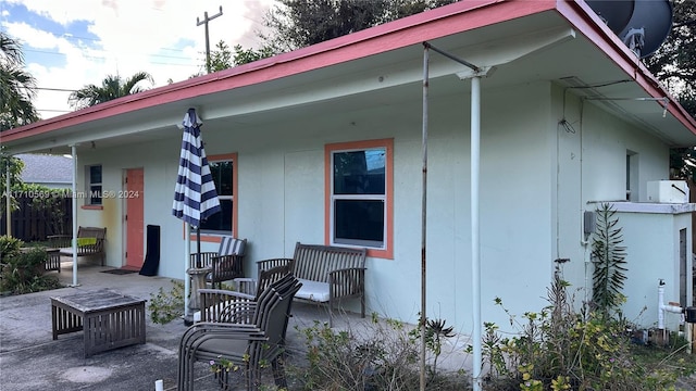 back of house featuring a porch