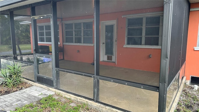 view of home's exterior with a sunroom