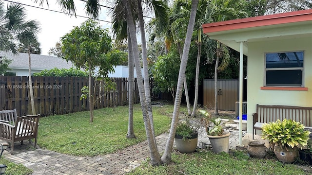 view of yard with a storage shed and a patio