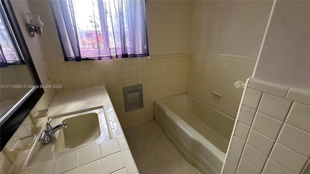 bathroom featuring tile patterned flooring, sink, tile walls, and a washtub