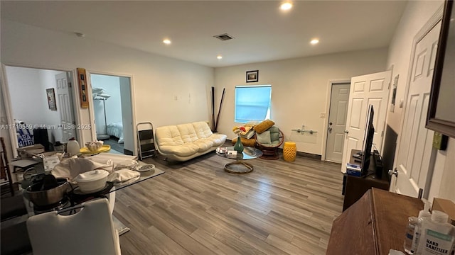 sitting room with hardwood / wood-style flooring