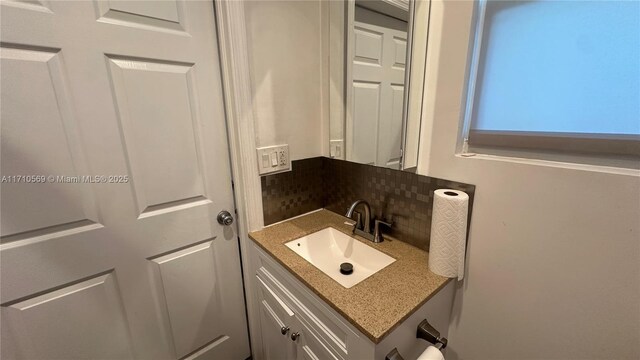 bathroom featuring tasteful backsplash and vanity