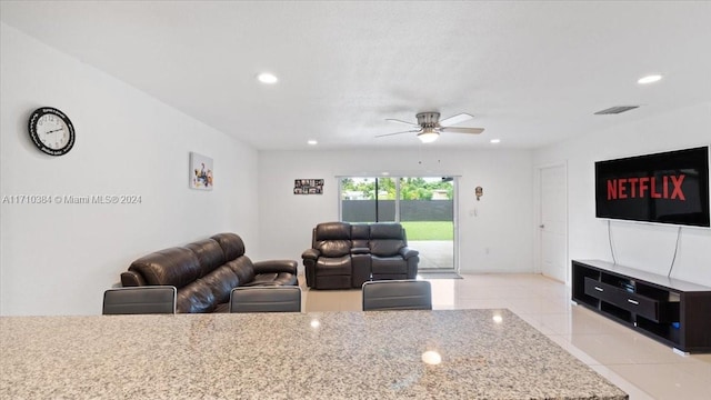 tiled living room featuring ceiling fan