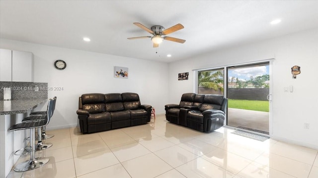 tiled living room featuring ceiling fan