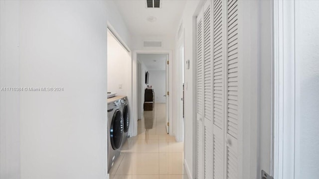 laundry room with light tile patterned floors and washer and dryer