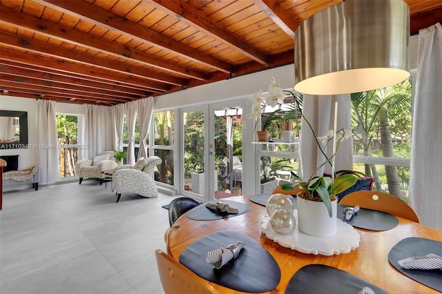 sunroom with french doors, beamed ceiling, and wooden ceiling