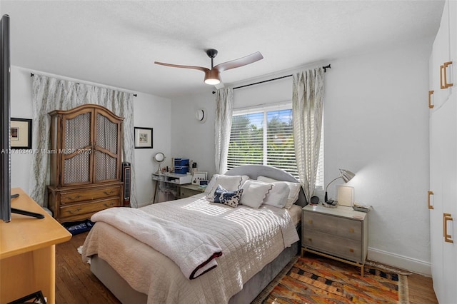 bedroom featuring dark hardwood / wood-style floors and ceiling fan