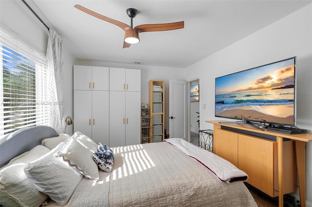 bedroom with hardwood / wood-style floors and ceiling fan