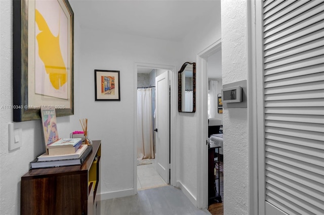 corridor with light hardwood / wood-style floors