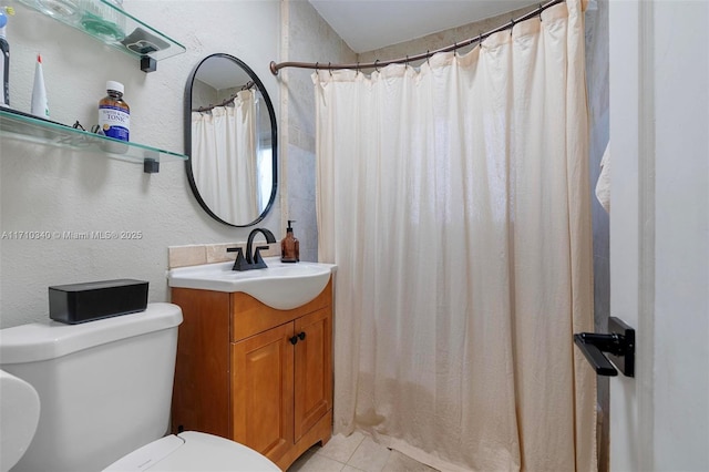 bathroom featuring tile patterned flooring, vanity, and toilet