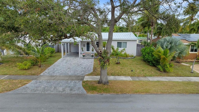 ranch-style home featuring a carport and a front yard