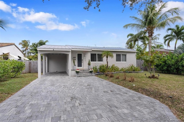 view of front facade featuring a front lawn and a carport