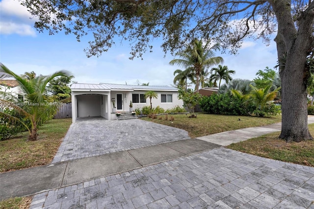 ranch-style home with a front yard and a carport