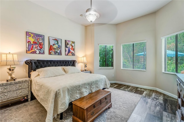 bedroom with ceiling fan and dark hardwood / wood-style flooring