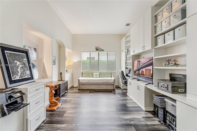 interior space with dark wood-style flooring, visible vents, and baseboards