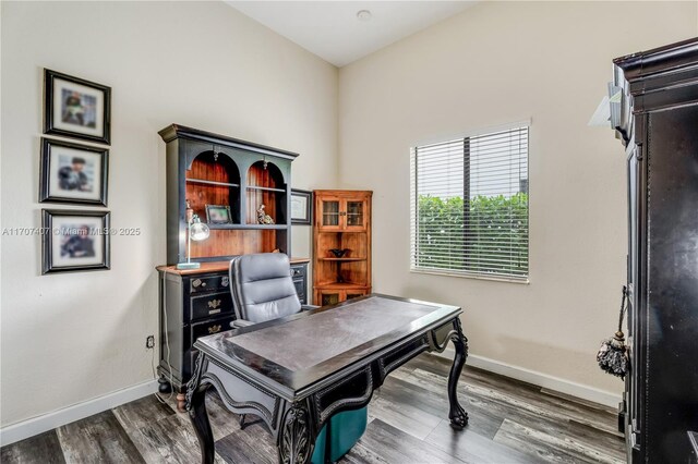 clothes washing area with hardwood / wood-style flooring, washer and dryer, cabinets, and an inviting chandelier