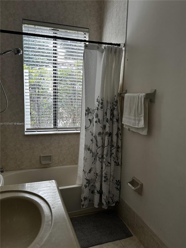 full bathroom featuring tile patterned flooring and shower / bath combo