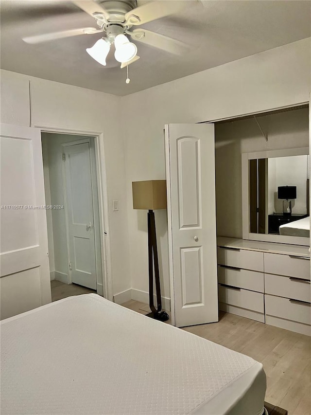 bedroom featuring ceiling fan, a closet, and light hardwood / wood-style flooring