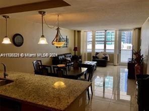 kitchen featuring light stone countertops and hanging light fixtures