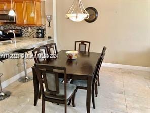 3725 S Ocean Dr Unit 1605, Hollywood, FL 33019 - dining area with baseboards and a chandelier