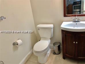 bathroom featuring tile patterned floors, vanity, and toilet