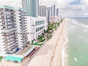 exterior space featuring a water view and a view of the beach