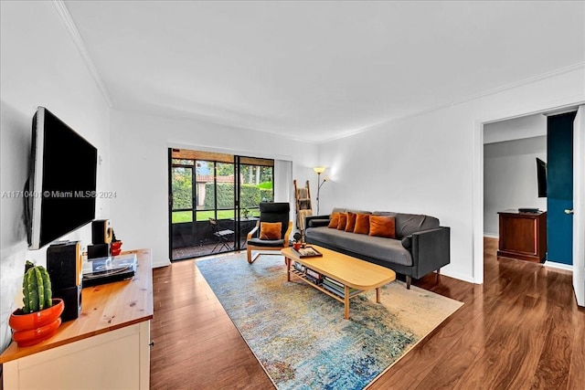 living room featuring dark hardwood / wood-style flooring and ornamental molding