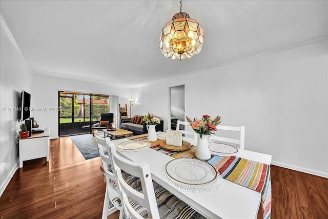 dining space featuring dark hardwood / wood-style flooring and ornamental molding