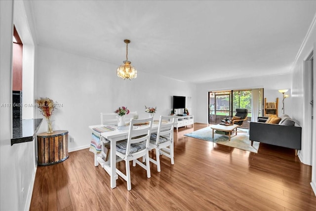 dining space with a chandelier and wood-type flooring