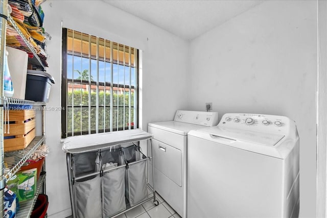 laundry area featuring light tile patterned floors and washer and clothes dryer