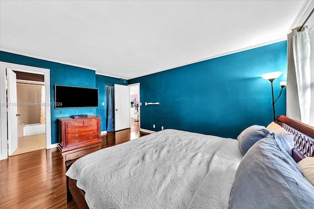 bedroom with hardwood / wood-style floors and crown molding