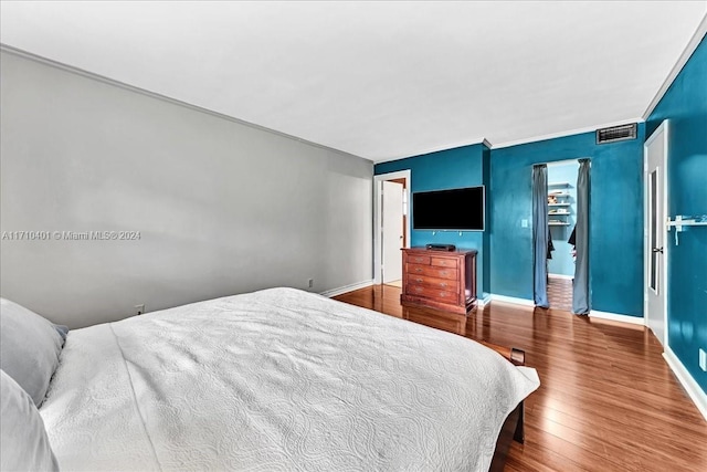 bedroom featuring hardwood / wood-style flooring and ornamental molding