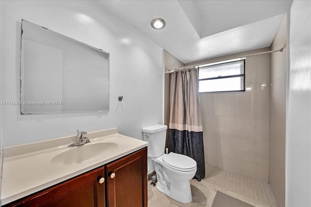 bathroom with a shower with curtain, vanity, and toilet