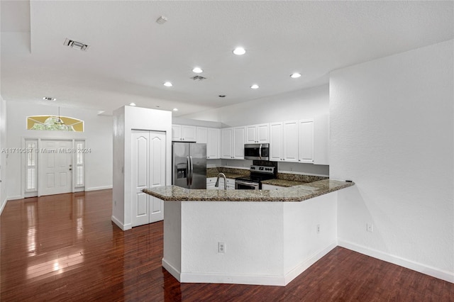 kitchen with sink, stainless steel appliances, dark hardwood / wood-style floors, kitchen peninsula, and white cabinets