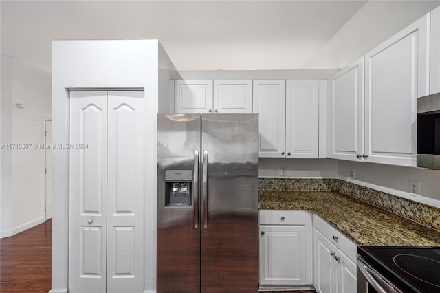 kitchen featuring stainless steel appliances, white cabinetry, dark hardwood / wood-style floors, and dark stone counters