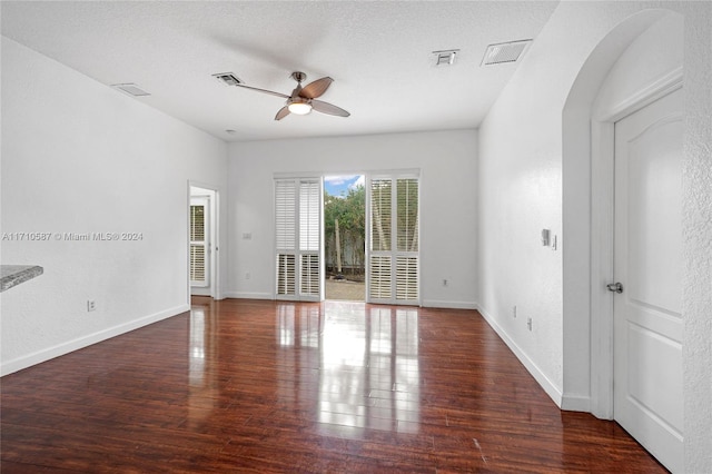 spare room featuring ceiling fan, dark hardwood / wood-style flooring, and a textured ceiling